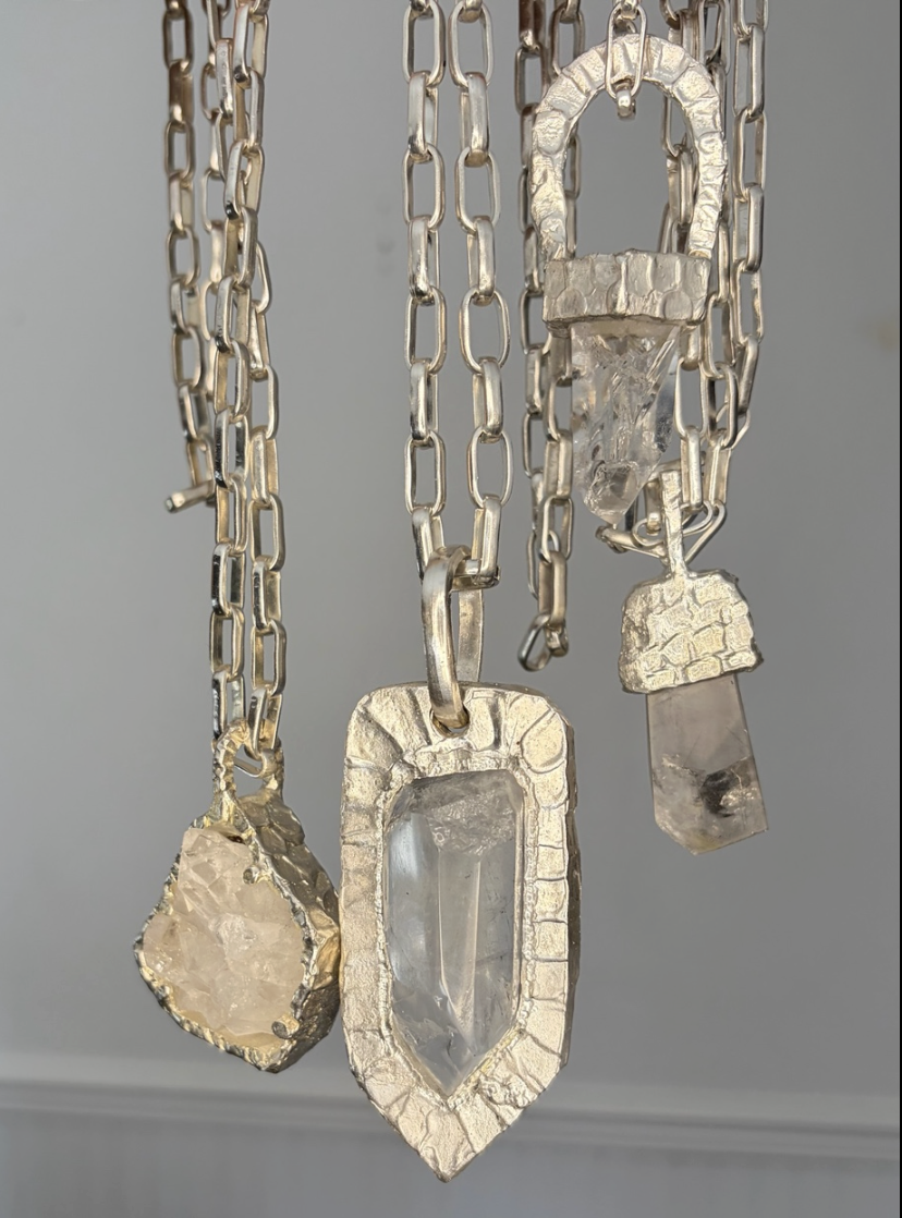 Three silver pendant necklaces with quartz stones, product shot