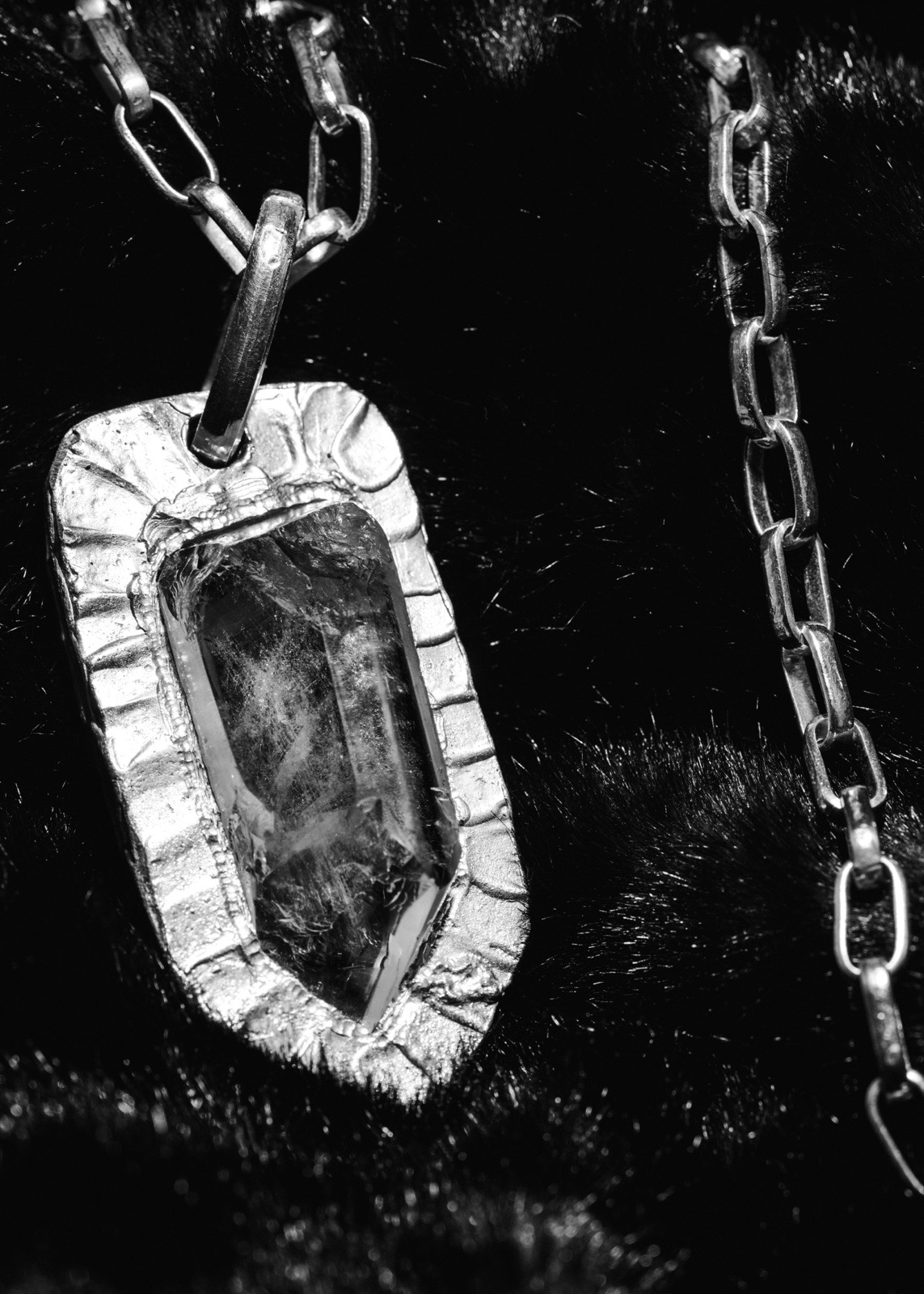 Silver pendant with a faceted quartz stone