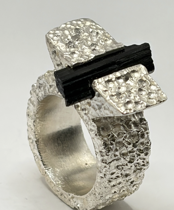 Silver ring with a black tourmaline bar accent, product shot
